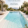 Piscine rectangulaire blanche avec escalier intégré entourée de plantes